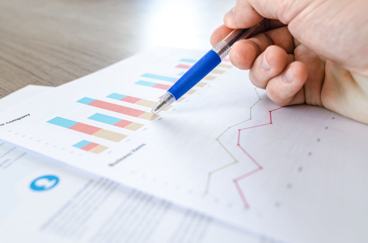 Hand marking up a printed analytics chart