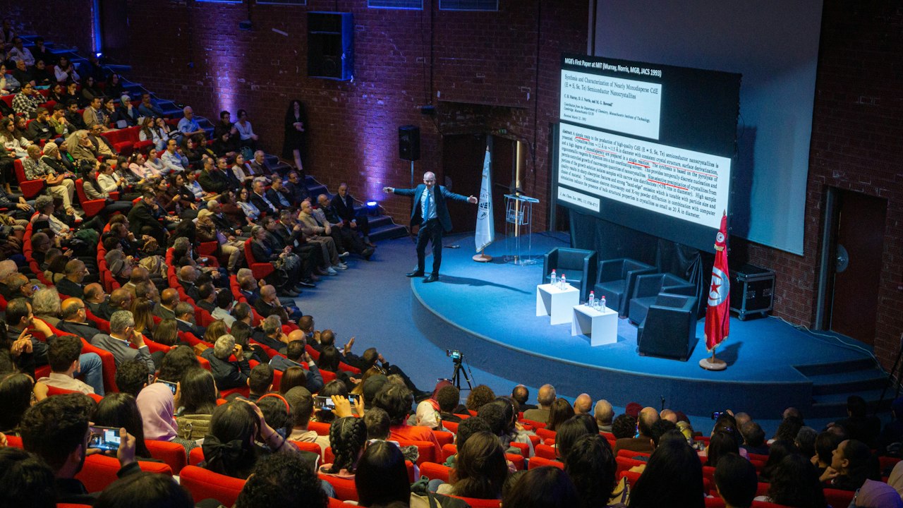 Speaker presenting to a large auditorium