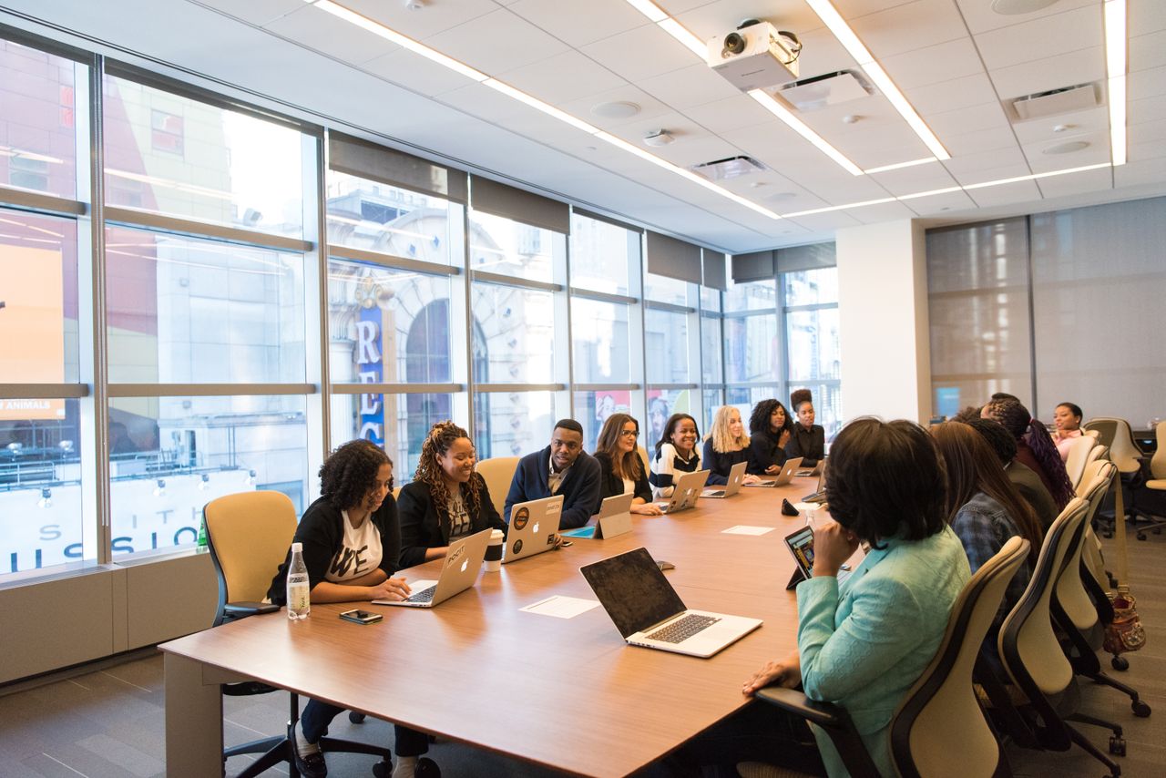 Team meeting in a glass-walled boardroom